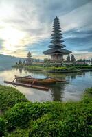 Canoe on Body of Water With Pagoda Background photo