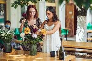 Two young women make up a beautiful festive bouquet. photo