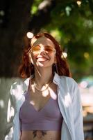 Young woman with toothy smile in outdoors photo