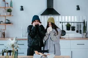 Warmly dressed women are upset with the heating turned off photo