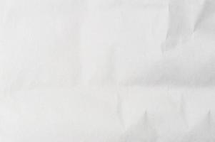Wrinkled or crumpled white stencil paper or tissue after use in toilet or restroom with large copy space used for background texture in decorative art work photo