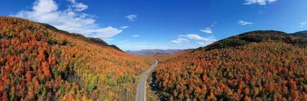 Peak fall foliage in Keene, New York by Cascade Lake. photo