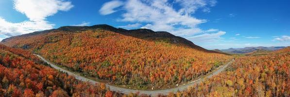 Peak fall foliage in Keene, New York by Cascade Lake. photo