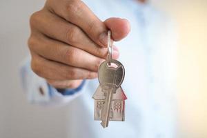 Landlord unlocks the house key for new home photo