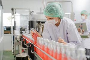 quality supervisor or food or beverages technician inspection about quality control food or beverages before send product to the customer. Production leader recheck ingredient and productivity. photo