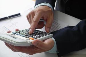 Bank staff or accountants use calculators for calculating and checking accounts. Accounting business financial concepts photo