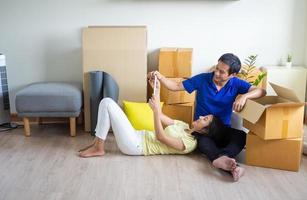 A happy young couple is moving to a new home. photo