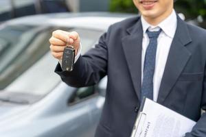 lease, rental car, sell, buy. Dealership manager send car keys to the new owner.  Sales, loan credit financial, rent vehicle, insurance,  renting, Seller, dealer, installment, car care business photo