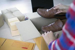 Young business women are preparing boxes to deliver products to online shoppers. SME business, small business concept photo