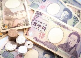 Japanese yen notes and Japanese yen coins for money concept background photo