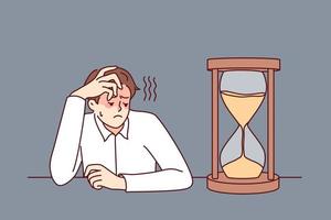 Exhausted businessman looking at hourglass feel bored and overwhelmed. Tired male employee look at sand clock wait for working day end. Vector illustration.