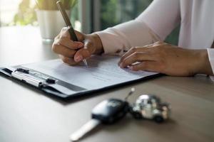 Signing of a car purchase contract. New car owner photo