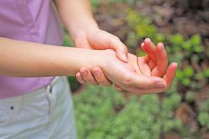 The woman holding her wrists had a wrist pain. Like office symptoms. photo