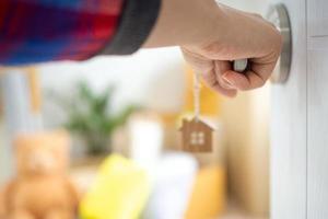 The new home owner opens the door of the room. Inside the room there are personal belongings that are going to be moved to keep correctly. House moving concept. photo