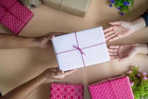 The child is receiving a gift from his mother on her birthday. photo