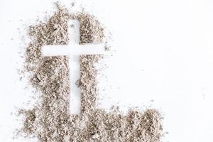 Christian cross or crucifix drawing in ash, dust or sand as symbol of religion, sacrifice, redemption, Jesus Christ, ash wednesday, lent, Good Friday, Easter with Church is devoted to fasting photo