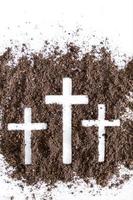 Christian cross or crucifix drawing in ash, dust or sand as symbol of religion, sacrifice, redemption, Jesus Christ, ash wednesday, lent, Good Friday, Easter with Church is devoted to fasting photo