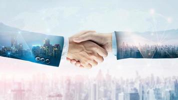 Successful businessman handshake startup new project at city skyline background, Double exposure of professional teamwork and network connection partnership concept, International business investment