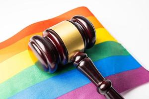 Gavel for judge lawyer on rainbow flag, symbol of LGBT pride month celebrate annual in June social of gay, lesbian, bisexual, transgender, human rights. photo