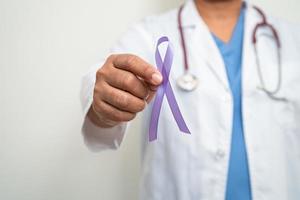 Asian woman doctor with purple ribbon, sign of Alzheimer disease day, Pancreatic cancer, Epilepsy, Lupus. photo