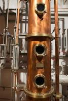 Copper still alembic inside distillery photo