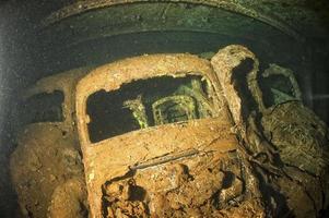 Old Car inside II world war ship wreck hold photo