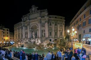 ROME, ITALY - NOVEMBER 24, 2012 - Rome Fountain di trevi night view crowded of tourists photo