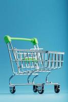 An empty supermarket cart on a blue background. photo