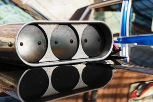 The throttle on the hood of the muscle car close-up. photo