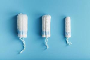 Cotton tampons on a blue background with a free space. photo