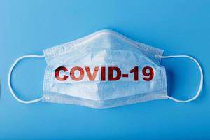 Medical masks for protection against dangerous coronavirus infection with the inscription COVID-19. photo