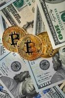 Bitcoin gold coins on US dollar bills. photo