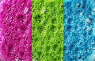 Multi-colored foam of three colors, pink, green and blue in a row. photo
