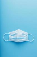 Medical mask on a blue background. Disposable face masks for viruses. Free space. photo
