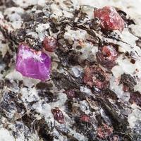 Corundum crystals in mineral stone close up photo