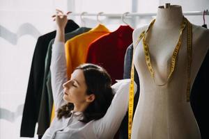 Beautiful lady blogger showing clothes in front of the camera to recording vlog video live streaming at her shop. Online Shopping Cart notion. photo