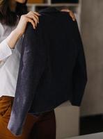 Beautiful lady blogger showing clothes in front of the camera to recording vlog video live streaming at her shop. Online Shopping Cart notion. photo