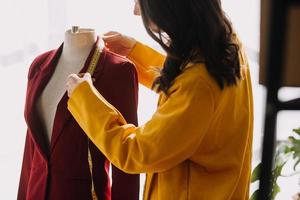 hermosa dama blogger demostración ropa en frente de el cámara a grabación vlog vídeo En Vivo transmisión a su tienda. en línea compras carro noción. foto