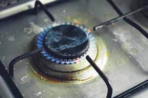 Burning dirty gas cooker. Close up image or burning gas. photo