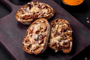 Delicious crispy toast or bruschetta with fried onion, champignon mushrooms and cheese photo