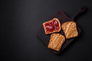 Nutritious sandwiches consisting of bread, raspberry jam and peanut butter photo