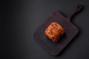 Delicious fresh smoked meat or ham with spices and herbs photo