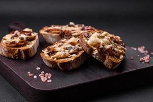 Delicious crispy toast or bruschetta with fried onion, champignon mushrooms and cheese photo