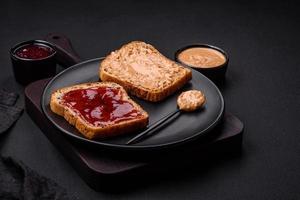 Nutritious sandwiches consisting of bread, raspberry jam and peanut butter photo