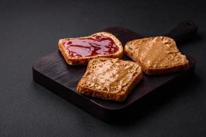 Nutritious sandwiches consisting of bread, raspberry jam and peanut butter photo