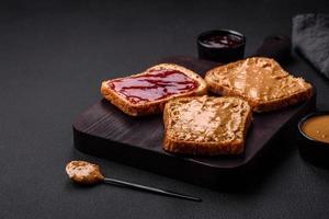 Nutritious sandwiches consisting of bread, raspberry jam and peanut butter photo