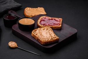 Nutritious sandwiches consisting of bread, raspberry jam and peanut butter photo