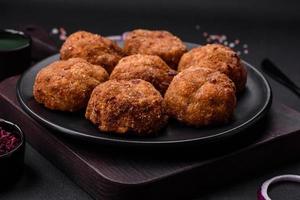Delicious fresh meat or vegetable cutlets with spices and herbs photo