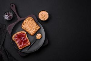 Nutritious sandwiches consisting of bread, raspberry jam and peanut butter photo