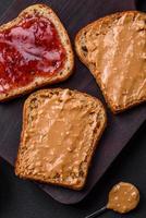 Nutritious sandwiches consisting of bread, raspberry jam and peanut butter photo